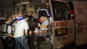 A wounded man is evacuated from the scene of a stabbing attack in Jaffa, a mixed Jewish-Arab part of Tel Aviv, Israel, Tuesday, March 8, 2016. (AP Photo/Oded Balilty)