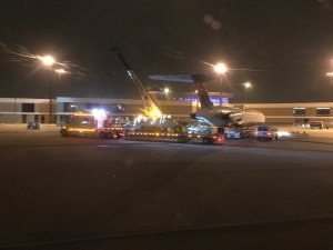 A new engine being installed on the plane.