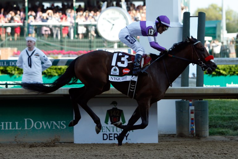 LOUISVILLE, KY - MAY 07: Nyquist #13, ridden by Mario Gutierrez, crosses the finish line to win the 142nd running of the Kentucky Derby at Churchill Downs on May 07, 2016 in Louisville, Kentucky. (Photo by Dylan Buell/Getty Images)