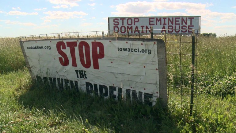 Signs protest Bakken oil pipeline construction. (WHO-HD)