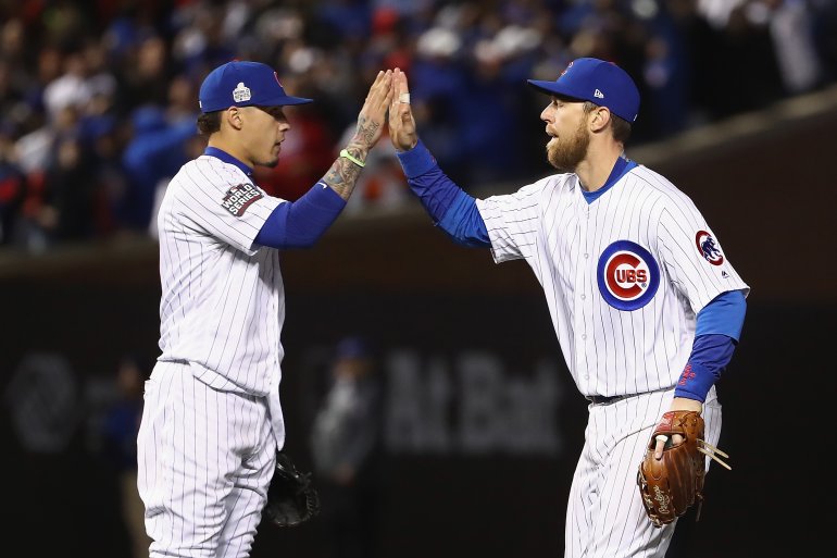 CHICAGO, IL - OCTOBER 30: Javier Baez #9 (L) and Ben Zobrist #18 of the Chicago Cubs celebrate after beating the Cleveland Indians 3-2 in Game Five of the 2016 World Series at Wrigley Field on October 30, 2016 in Chicago, Illinois. (Photo by Elsa/Getty Images)