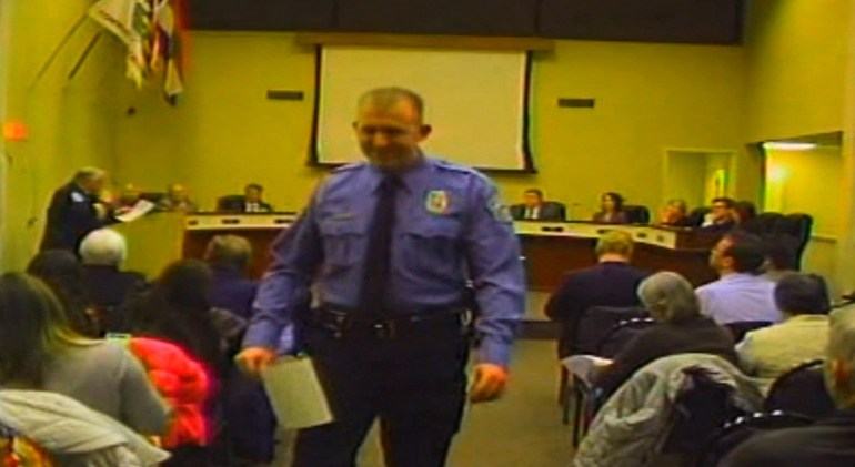 In this February 11, 2014 image from video released by the City of Ferguson, Missouri, officer Darren Wilson attends a city council meeting. 