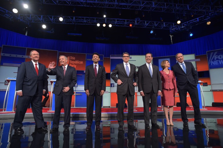 Republican presidential hopefuls (L-R) Jim Gilmore, Lindsey Graham, Bobby Jindal, Rick Perry, Rick Santorum, Carly Fiorina and George Pataki arrive on stage for the start of the Republican presidential primary debate on August 6, 2015 at the Quicken Loans Arena in Cleveland, Ohio. The seven candidates will debate before the top 10 candidates face off during prime time. (Mandel Ngan/AFP/Getty Images)