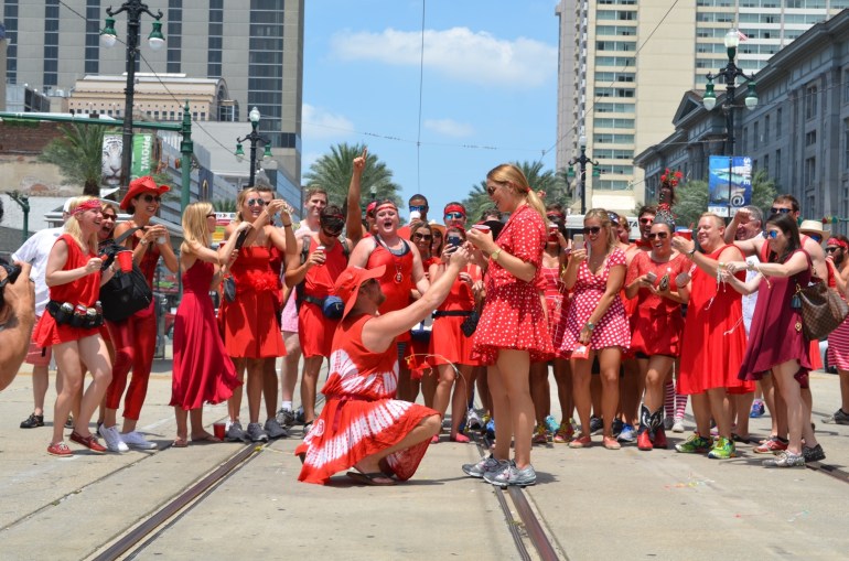 Congratulations! Wally proposed to his girlfriend Rachel in front of a big crowd on Canal Street during the Red Dress Run Saturday, August 8, 2015. (Credit: Josh Schulingkamp)