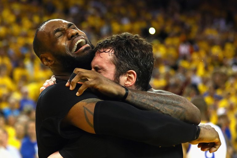LeBron James #23 and Kevin Love #0 of the Cleveland Cavaliers celebrate after defeating the Golden State Warriors 93-89 in Game 7 of the 2016 NBA Finals at ORACLE Arena on June 19, 2016 in Oakland, California. (Ezra Shaw/Getty Images)