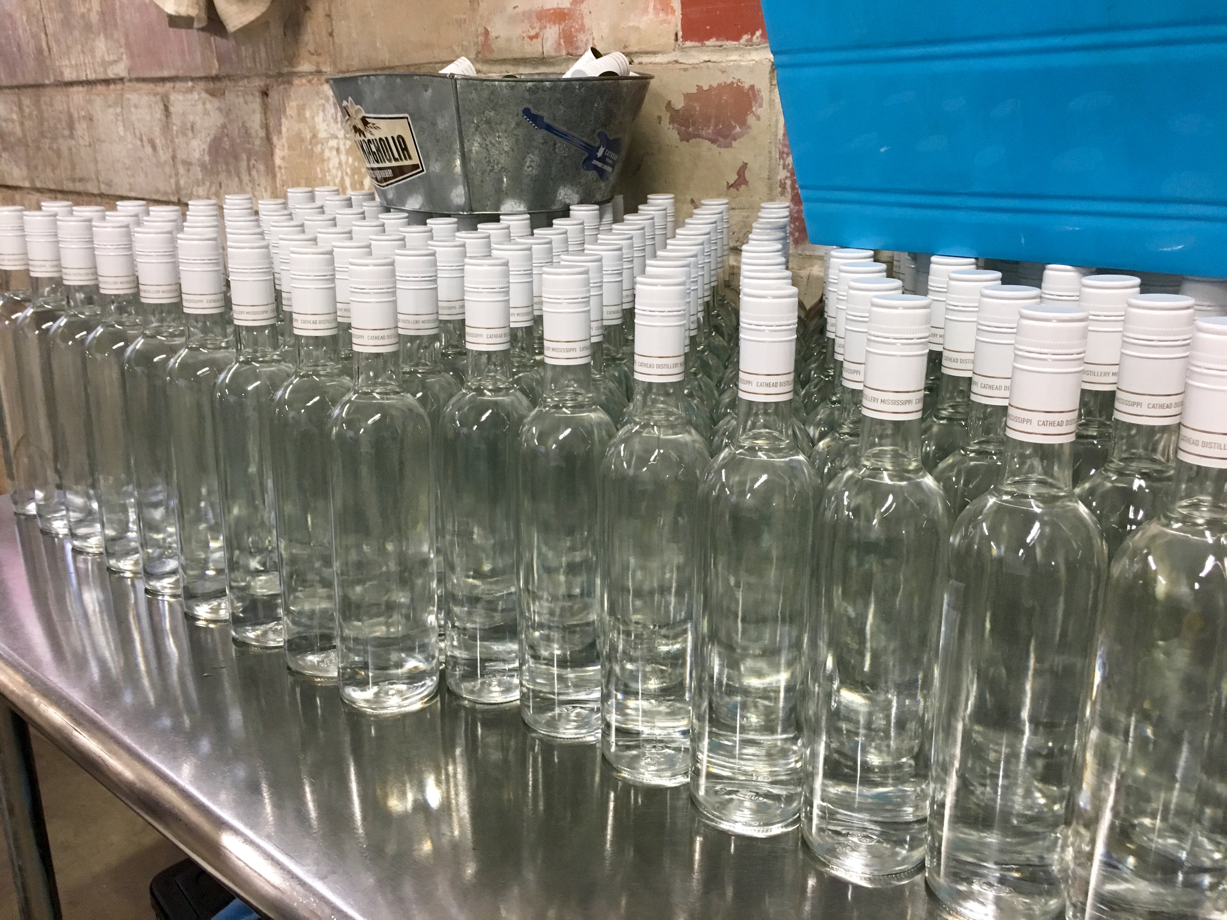 Naked bottles on the assembly line at Cathead Distillery.