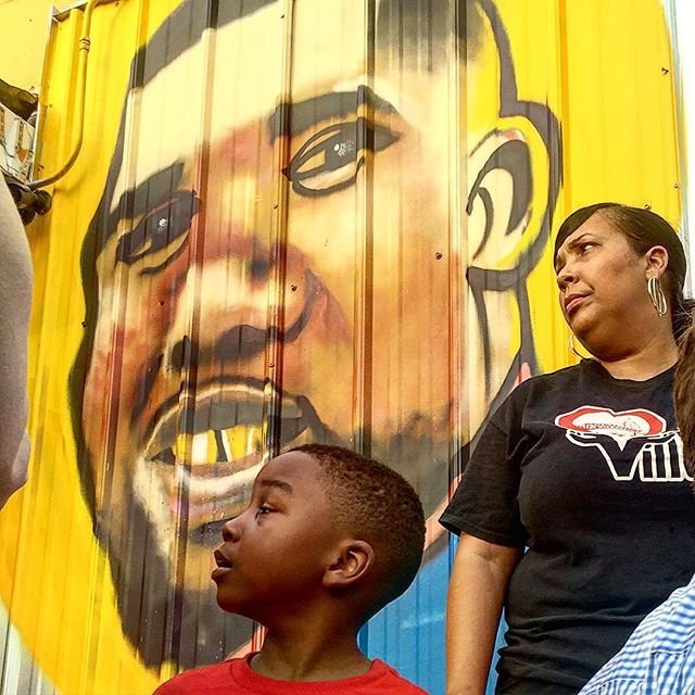 At an vigil for Alton Sterling, an artist painted a mural of Sterling on the wall outside of the store where he was fatally shot by police. Savidge posted the progression of the mural on Instagram. In the latest post, one of Sterling's sons is shown looking at a picture of his father in front of the mural. (Martin Savidge/CNN)