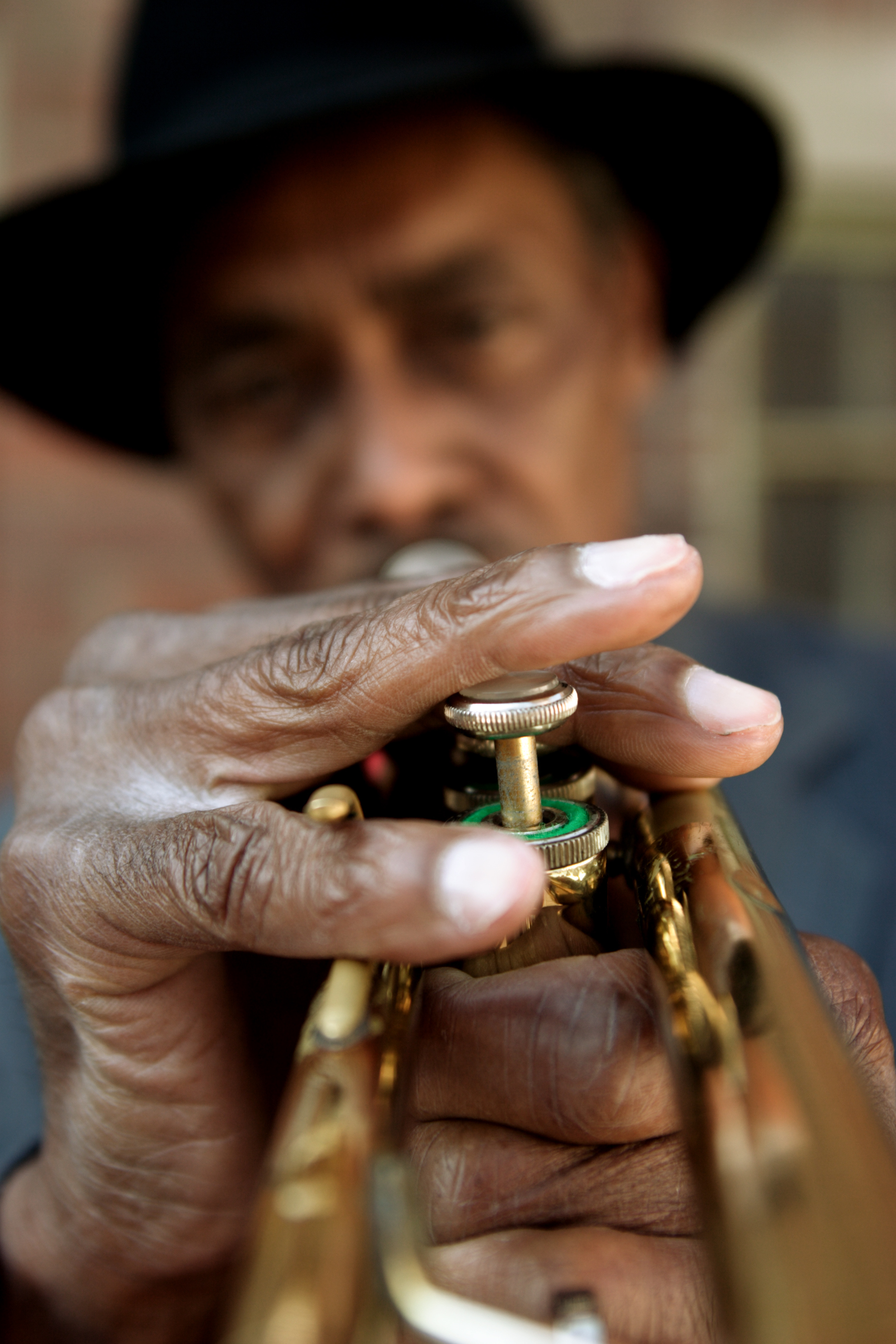 Man playing an old French Quarter trumpet.