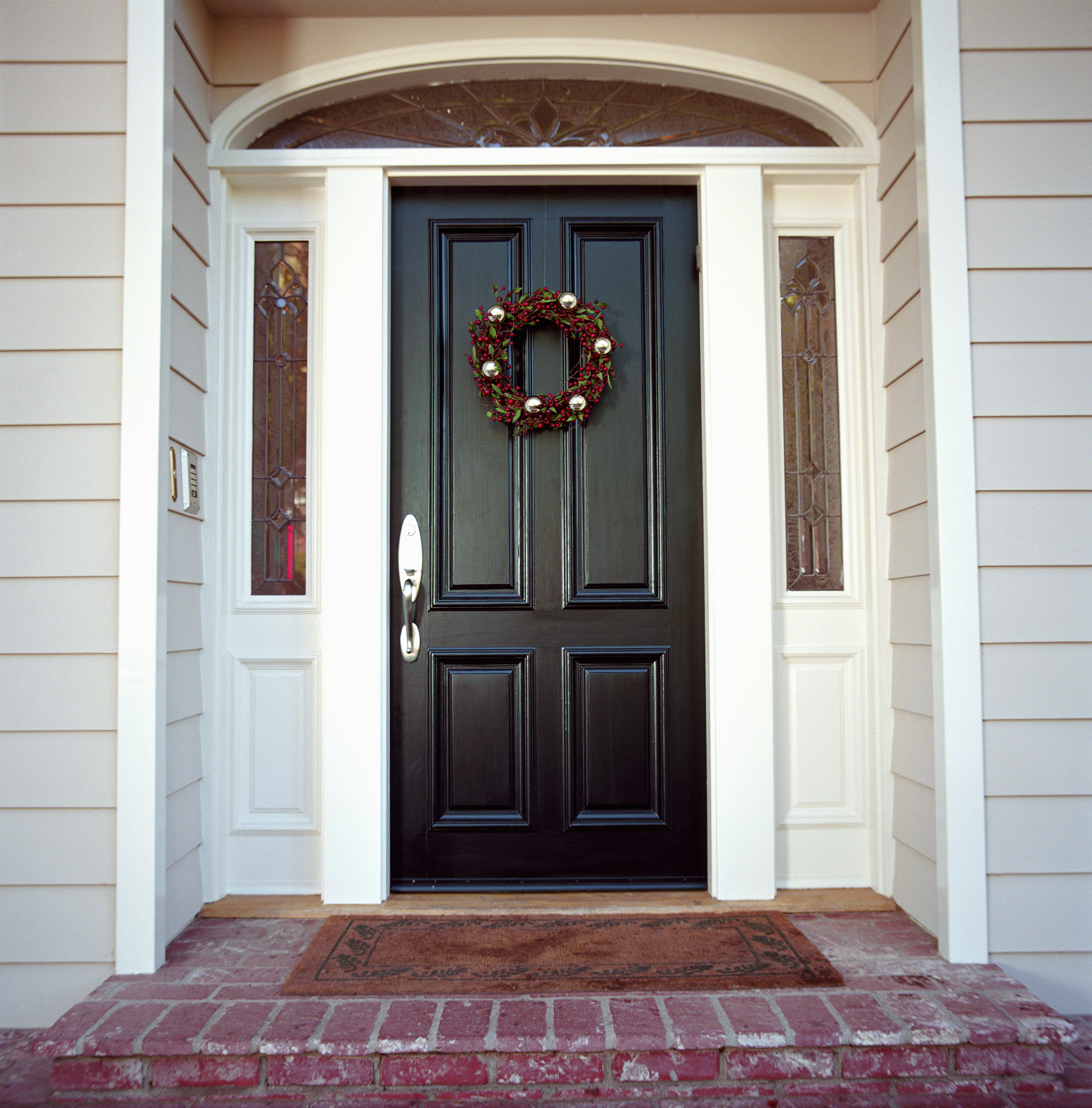 Christmas wreath on front door of house.