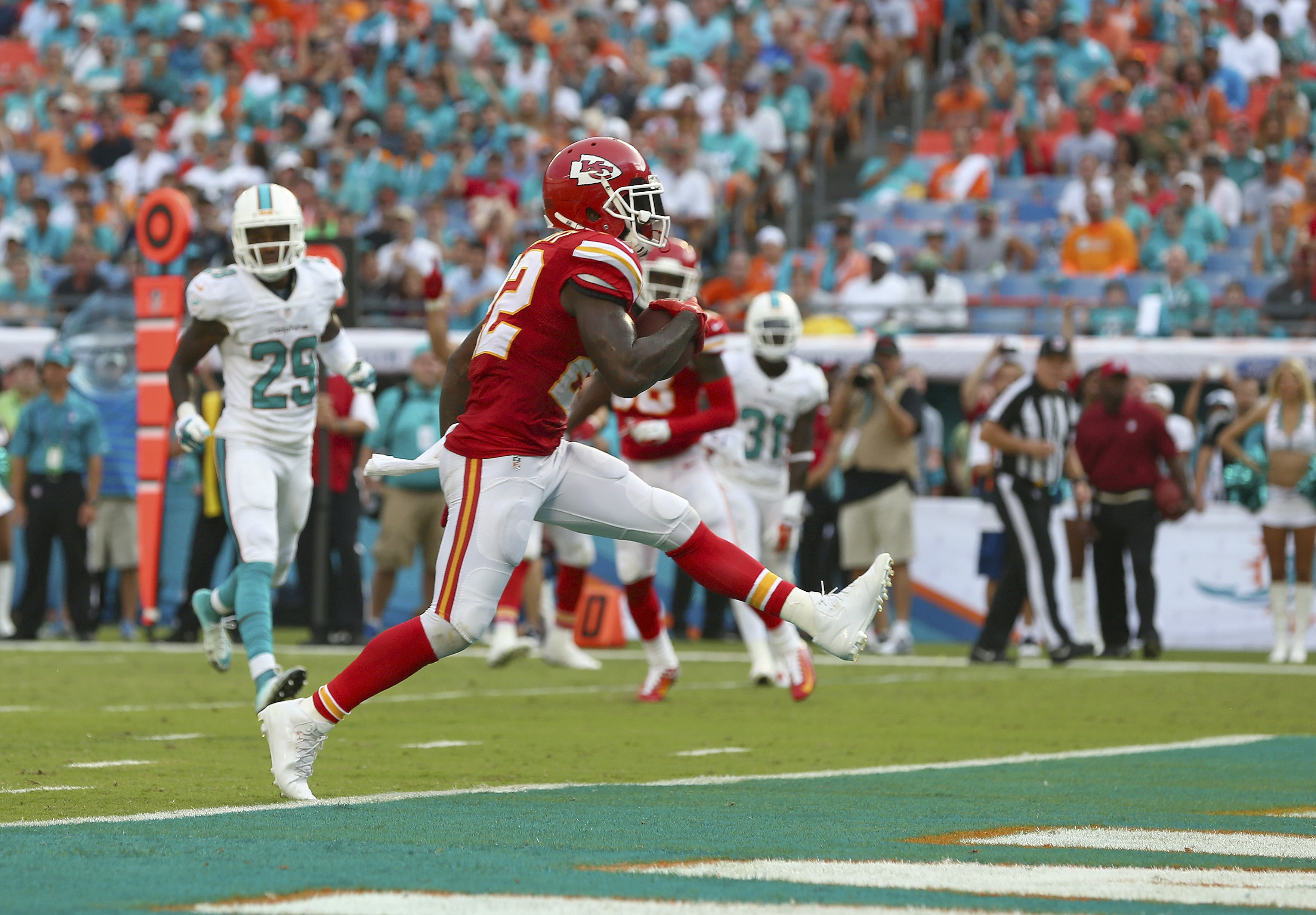 MIAMI GARDENS, FL - SEPTEMBER 21:  Running back Joe McKnight #22 of the Kansas City Chiefs scores a third-quarter touchdown against the Miami Dolphins at Sun Life Stadium on September 21, 2014 in Miami Gardens, Florida.  (Photo by Ronald Martinez/Getty Images)