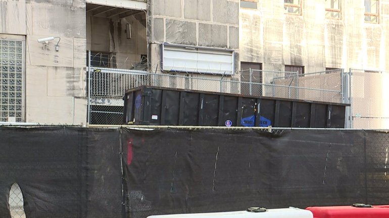 Dumpsters sit outside the old Charity Hospital as cleanup begins.