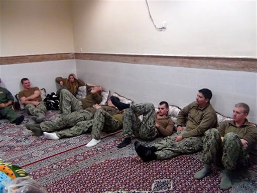 This picture released by the Iranian Revolutionary Guards on Wednesday, Jan. 13, 2016, shows detained American Navy sailors in an undisclosed location in Iran. Iranian state television is reporting that all 10 U.S. sailors detained by Iran after entering its territorial waters have been released. Iran's Revolutionary Guard said the sailors were released Wednesday after it was determined that their entry was not intentional. (Sepahnews via AP)