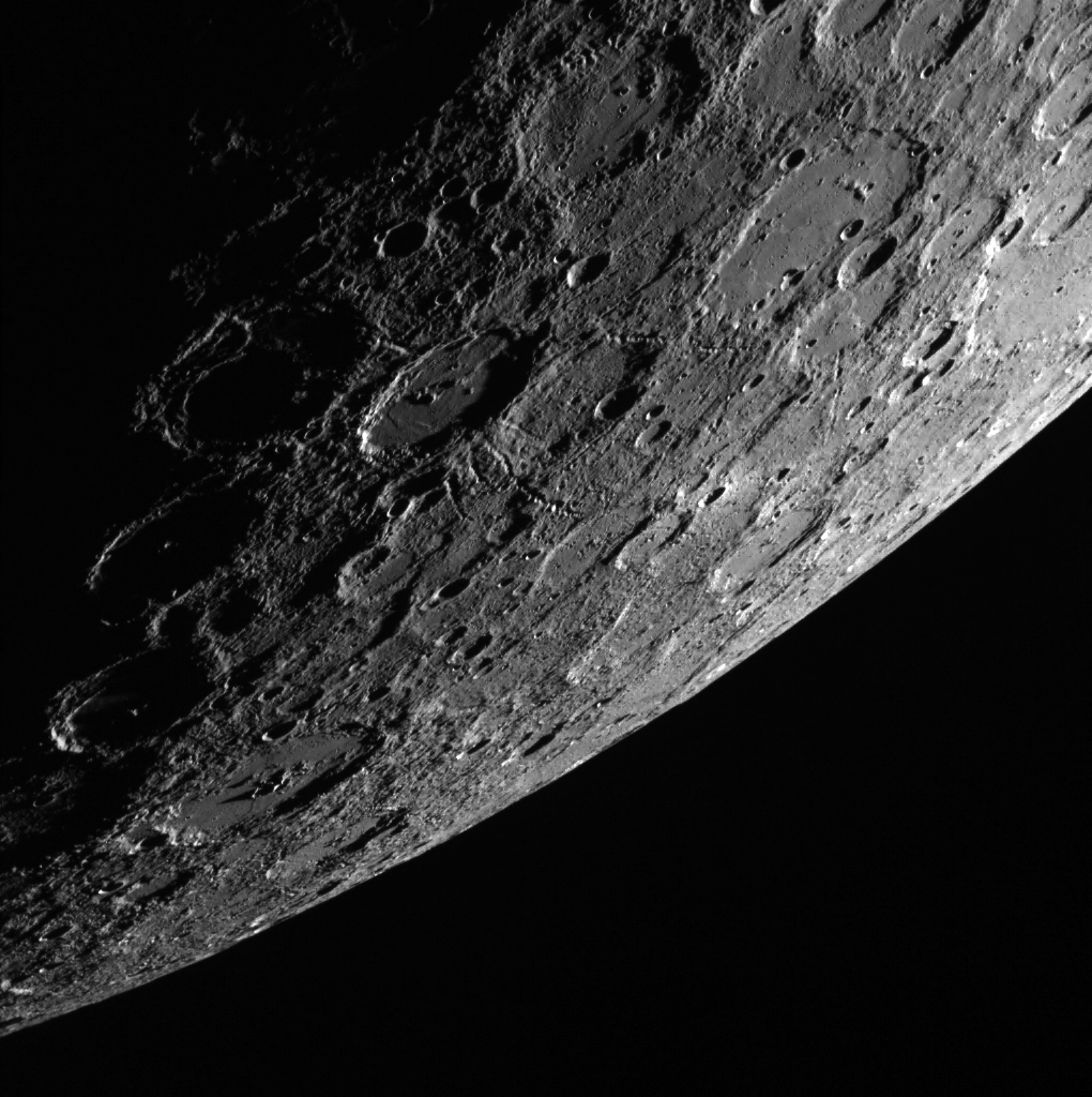In this scene, which was acquired by the MESSENGER spacecraft looking from the shadows toward the sunlit side of the planet Mercury, a 120-km (75 mi.) impact crater stands out near the center. (Image: NASA.gov)