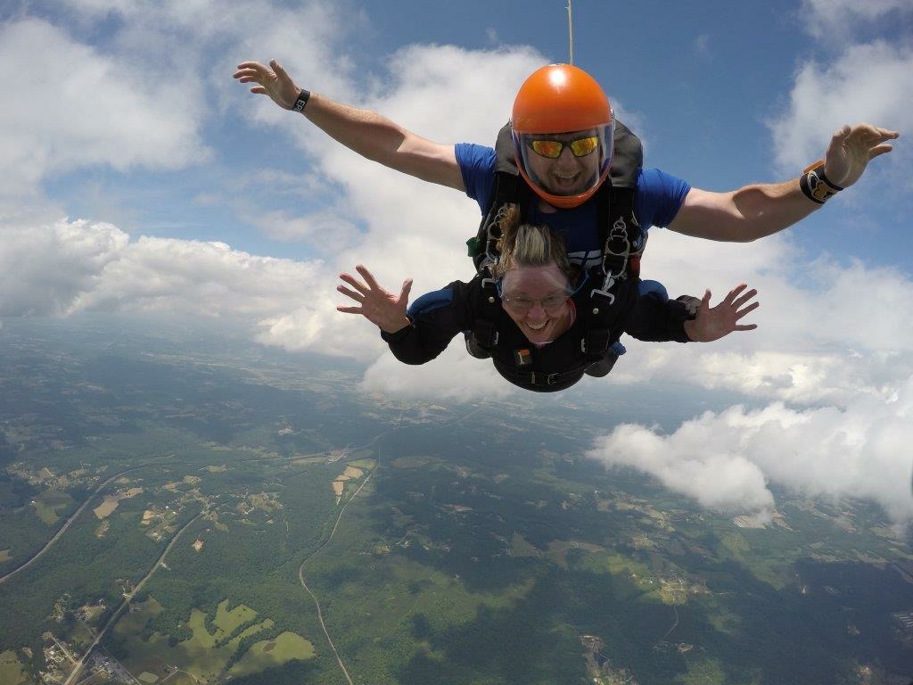 Pat, who recently turned 80, and Eddie as he guides her through her first skydive. (Image: Skydive Alabama)