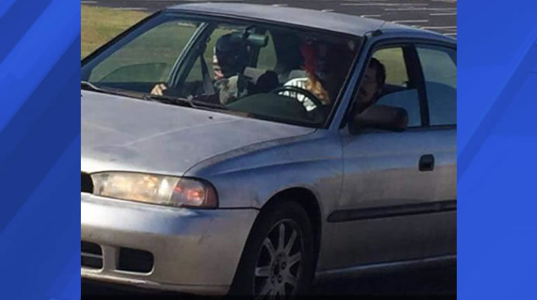 A photo of people dressed as clowns, spotted in a silver car at Meridianville Middle School earlier this week. (Photo: Facebook)