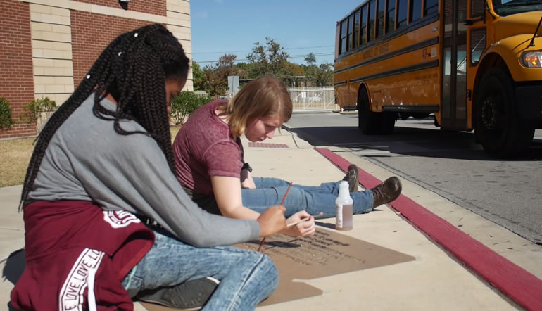 Lee High School Creative Writing Magnet students painted the 'invisible poetry' on sidewalks at their school and downtown on the courthouse square. (Image: Arts Huntsville)