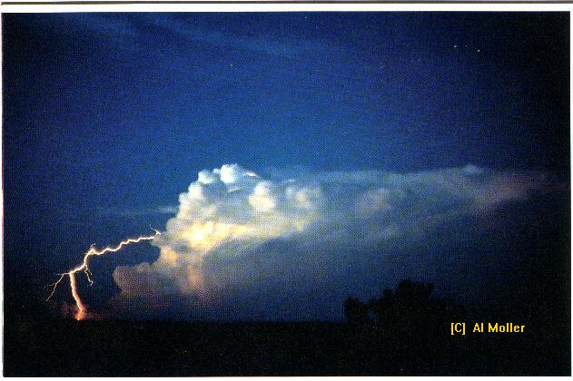 A lightning bolt emanates from the top of a cumulonimbus cloud to an area of the ground free fro rain. This is an example of a "bolt from the blue" and illustrates how lightning can strike as far as 10 miles from its parent cloud. (Source: National Weather Service/Al Moller)