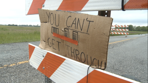 This hand written sign is meant to ward off drivers who disregard the posted "Road Closed" sign on Whiteland Road.