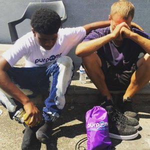 LaRon Tunstill comforts a man after giving him his new shoes.