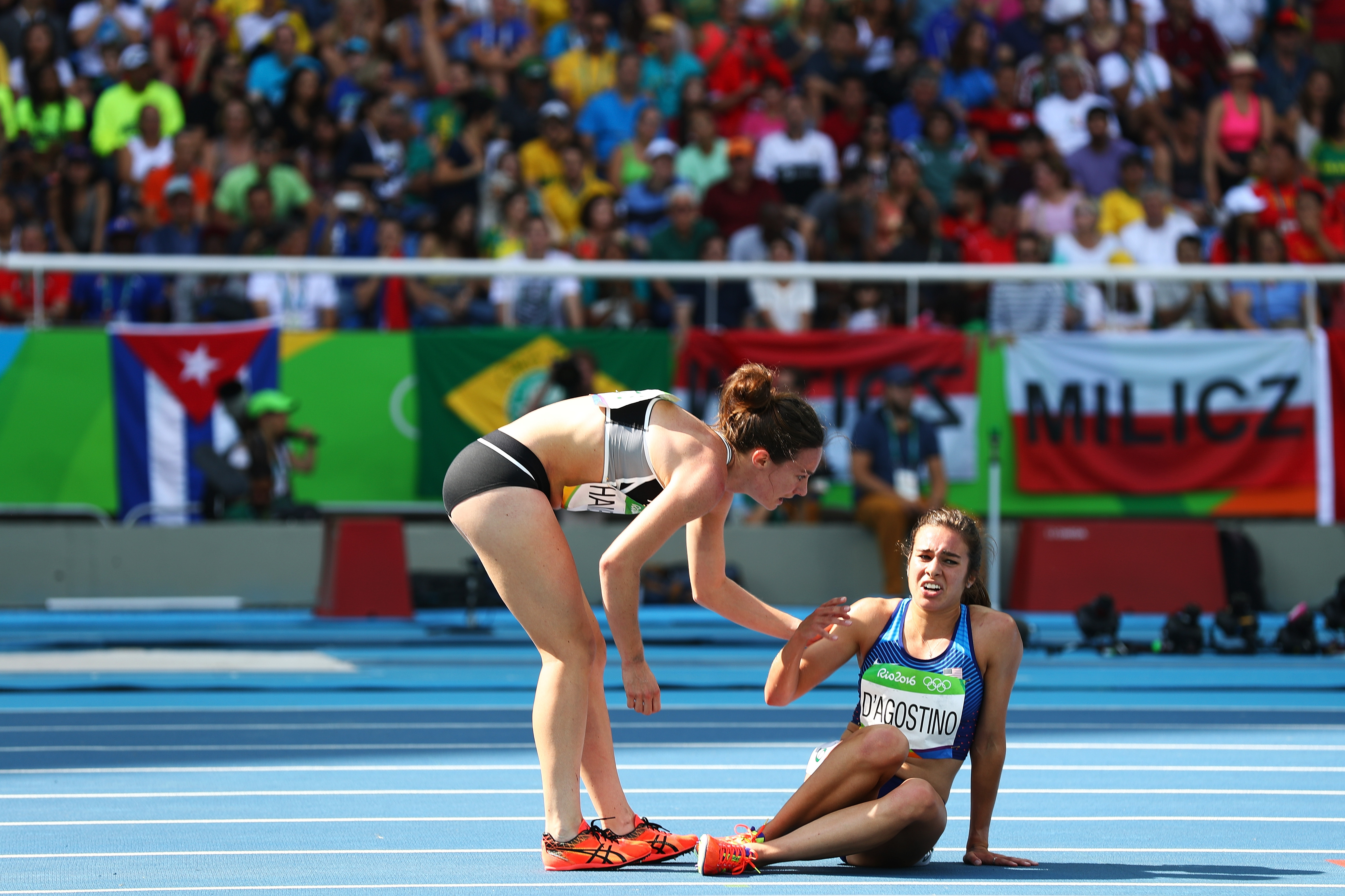 RIO DE JANEIRO, BRAZIL - AUGUST 16:  Abbey D'Agostino of the United States (R) is assisted by Nikki Hamblin of New Zealand after a collision during the Women's 5000m Round 1 - Heat 2 on Day 11 of the Rio 2016 Olympic Games at the Olympic Stadium on August 16, 2016 in Rio de Janeiro, Brazil.  (Photo by Ian Walton/Getty Images)