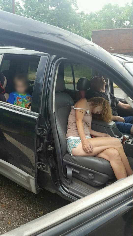 The Liverpool Police Department posted shocking photos to Facebook showing two adults, who police believe were on heroin, passed out in a car with a little boy in the backseat. (Photo Credit: East Liverpool Police)