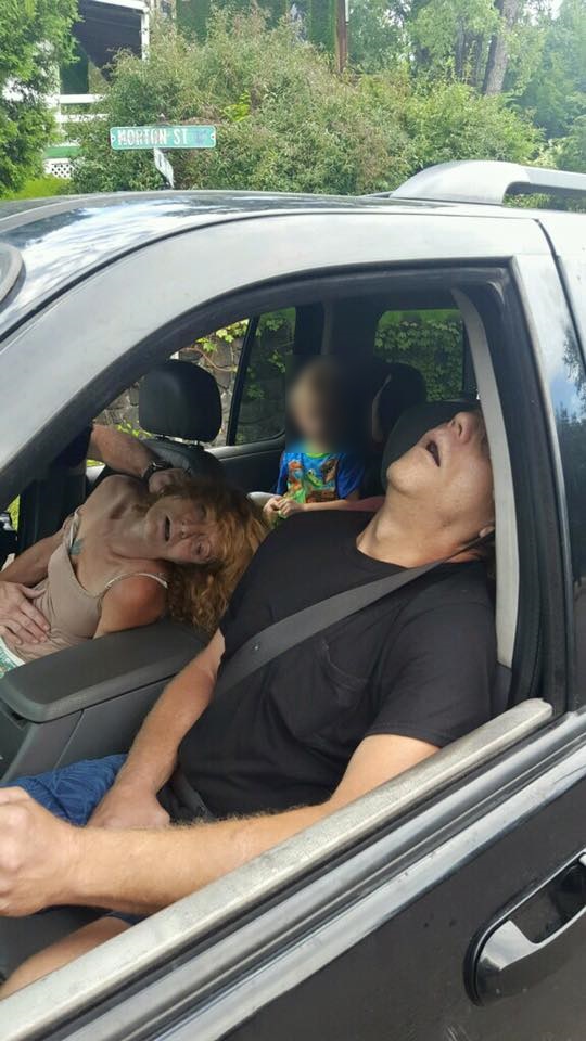 The Liverpool Police Department posted shocking photos to Facebook showing two adults, who police believe were on heroin, passed out in a car with a little boy in the backseat. (Photo Credit: East Liverpool Police)