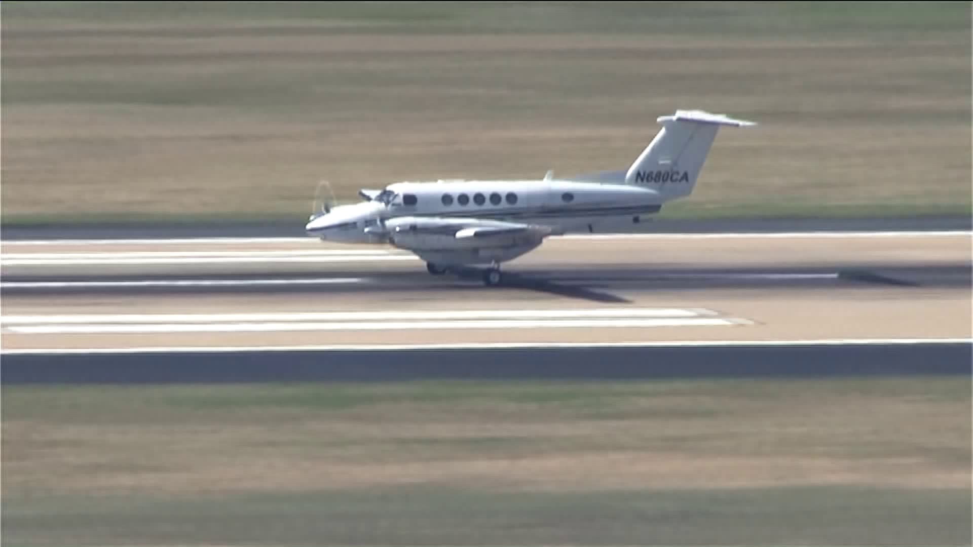 (2/4) Plane hits the runway, preparing to stop.