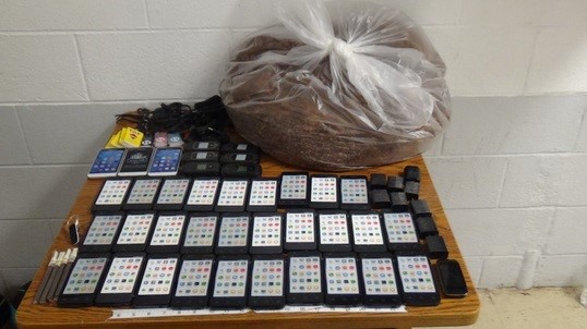 The contraband drop contianed 39 cellphones and nearly 10 pounds of tobacco