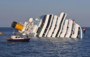 GIGLIO PORTO, ITALY - JANUARY 14: The cruise ship Costa Concordia lies stricken off the shore of the island of Giglio, on January 14, 2012 in Giglio Porto, Italy. More than four thousand people were on board when the ship hit a sandbank. At least 3 people have been confirmed dead and another 50 are unaccounted for. (Photo by Laura Lezza/Getty Images)