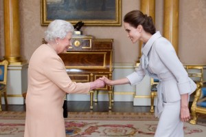 Actress Angelina Jolie was presented with the Insignia of an Honorary Dame Grand Cross of the Most Distinguished Order of St Michael and St George by Queen Elizabeth II in the 1844 Room on Friday, Oct. 10, 2014 at Buckingham Palace, London. Jolie received an honorary damehood for services to UK foreign policy and the campaign to end war zone sexual violence. (Credit: Anthony Devlin - WPA Pool/Getty Images)