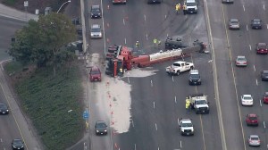 A semi truck carrying a crane overturned in lanes on the northbound 5 Freeway in San Clemente on Oct. 30, 2014. (Credit: KTLA)