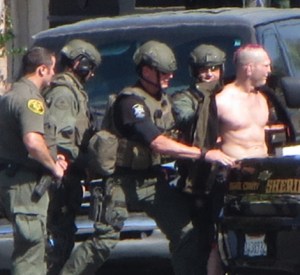 Jason "Mayhem" Miller is shown during his arrest after a standoff that he live-tweeted on Oct. 9, 2014, in Mission Viejo. (Credit: Chip Yost / KTLA)