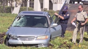 Investigators examine a car that struck Ventura County Deputy Eugene Kostiuchenko on Oct. 28, 2014. (Credit: KTLA)