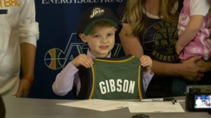 J.P. Gibson, a 5-year-old boy battling cancer, signed with the Utah Jazz on Oct. 8, 2014, (Credit: KSTU via CNN)