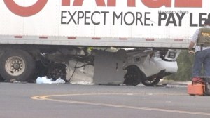 The 21-year-old driver of  a sedan was killed when the car collided with a semitrailer in Jurupa Valley, authorities said. (Credit: Newspro News)
