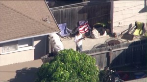 Aerial video showed a man emerging from the home carrying what appeared to be a rifle. (Credit: KTLA)