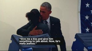 President Obama kisses a woman after her boyfriend jokingly told him not to touch her. (Credit: CNN)