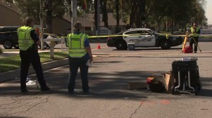 Investigators worked at the scene where a boy was killed at the intersection of Arrow Highway and Benson Avenue, shown, on Oct. 23, 2014. (Credit: KTLA)