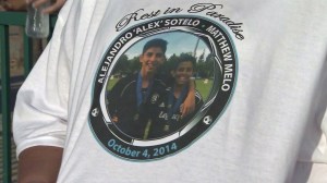 A photo of Alejandro Sotelo and Matthew Melo is seen on a T-shirt at a memorial vigil for the boys in San Juan Capistrano on Saturday, Oct. 11, 2014. (Credit: KTLA)