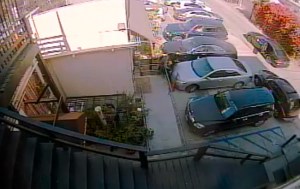 Surveillance video showed a 69-year-old woman being held down by three men who steal her Rolex watch. (Credit: LAPD)