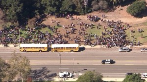 A large crowd is seen outside Palisades High School after the campus was evacuated due to a threat posted on social media on Tuesday, Nov. 4, 2014. (Credit: KTLA)