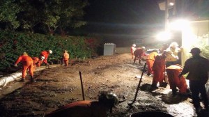 Crews worked to remove mud from a Glendora home after heavy rainfall on Nov. 21, 2014. (Credit: KTLA)