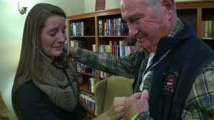 Case Heisler listens to her brother's heartbeat inside the man whose life was saved because of the transplant. (Credit: CNN) 