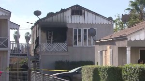 Investigators worked at the scene where two children died in a residential fire in San Bernardino on Nov. 20, 2014. (Credit: KTLA)