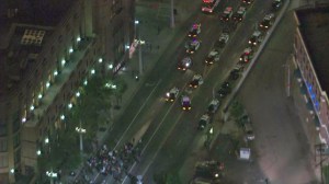 The first of hundreds of protesters face a long line of LAPD squad cars near Union Station in downtown on Nov. 27, 2014. (Credit: KTLA)