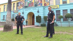 Police officers stand in front of Miramonte Elementary School in the wake of allegations against a former teacher there. (Credit: KTLA)