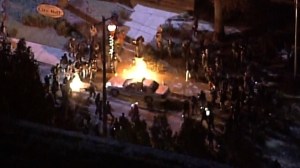 Protesters flip a police car in Ferguson and set it on fire. (Credit: Pool) 