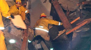 Firefighters search for victims after an explosion leveled a home in Muscoy on Thursday, Nov. 20, 2014. (Credit: San Bernardino Fire Department)