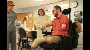 Will Lautzenheiser lost his limbs in 2011, but he received two arm transplants in Boston. Here, Lautzenheiser meets with members of the plastic surgery transplant clinical care team in June 2014 at Brigham and Women's Hospital. (Credit: Brigham and Women's Hospital)