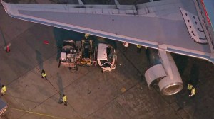 A truck driver was extricated after a fuel truck crashed into a plane at LAX on Nov. 3, 2014. (Credit: KTLA)